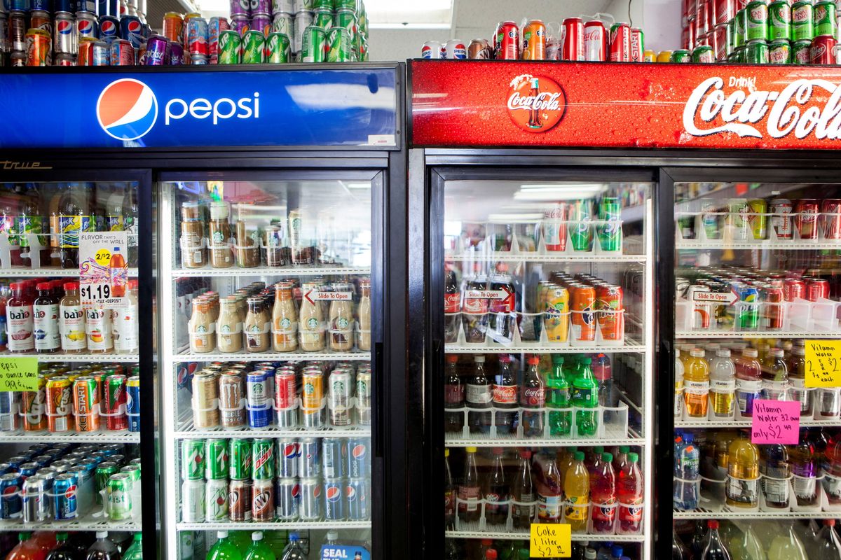 Cans of soda are displayed in a case at Kwik Stops Liquor in San Diego