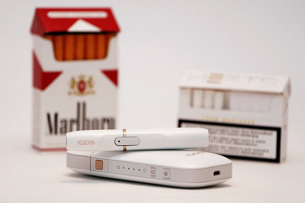 IQOS heat-not-burn device and a Marlboro cigarette pack 