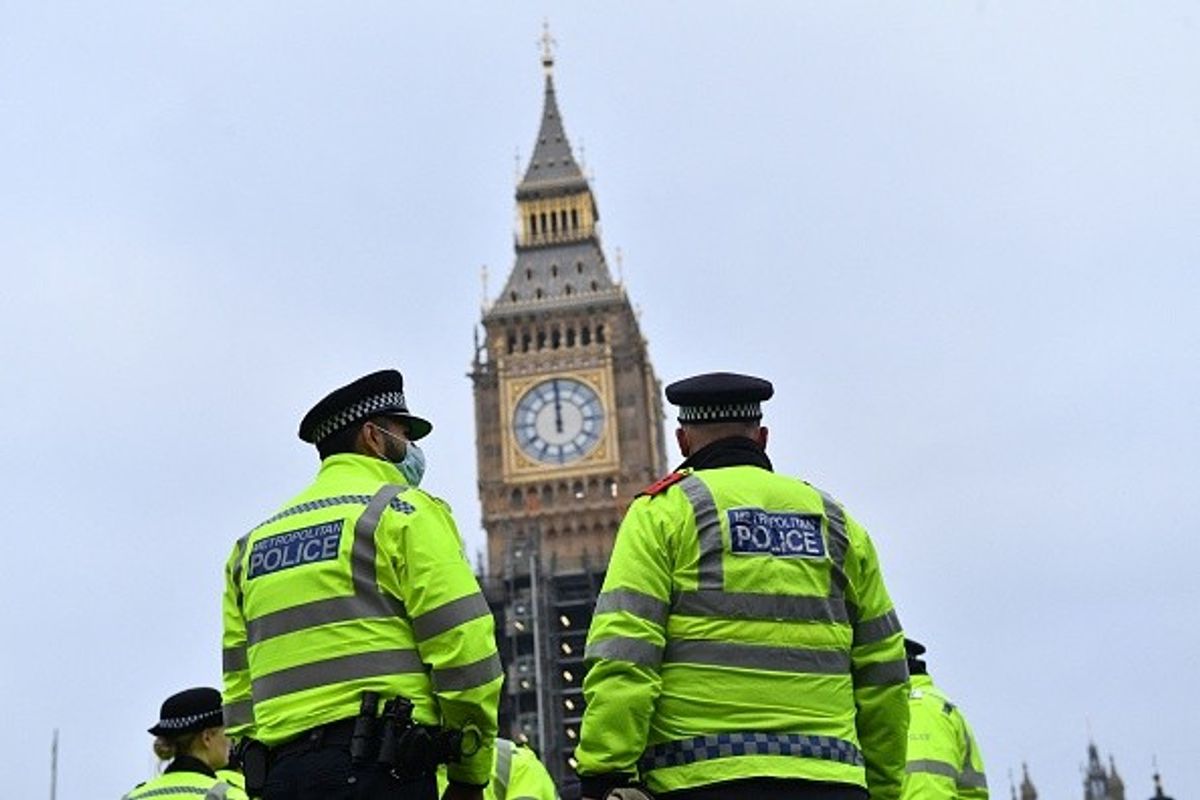 Police officers stand in sight of the Elizabeth Tower