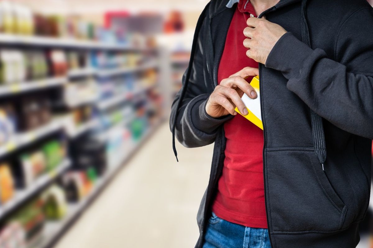 Retail Shoplifting. Man Stealing In Supermarket