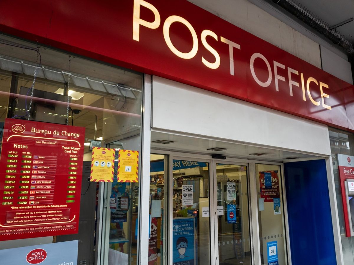 The shop sign and entrance of a branch of the Post Office.